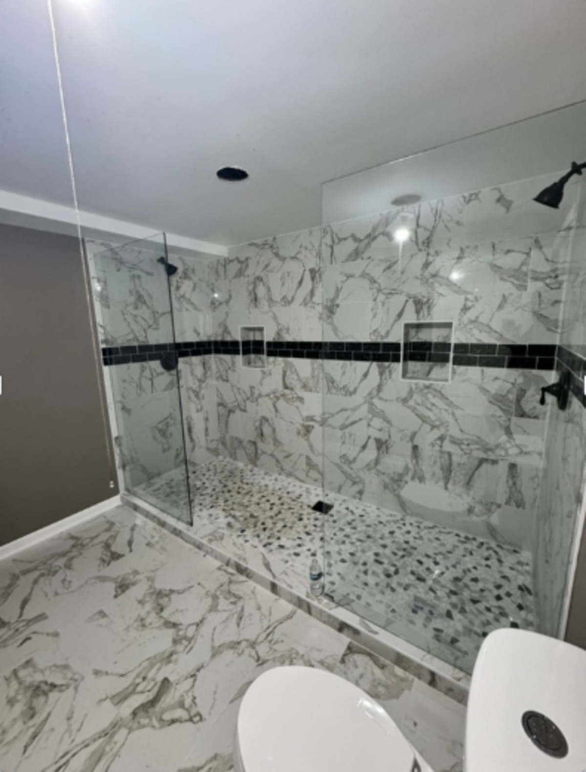 Completed bathroom renovation with tiled walk-in shower